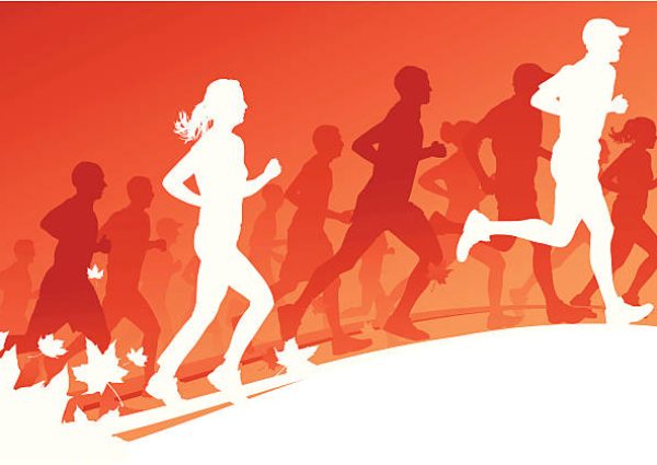 A big group of running people in a autumn race with plenty of copy space.